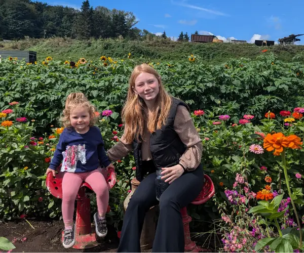 Whitney Quillin with kids in a garden